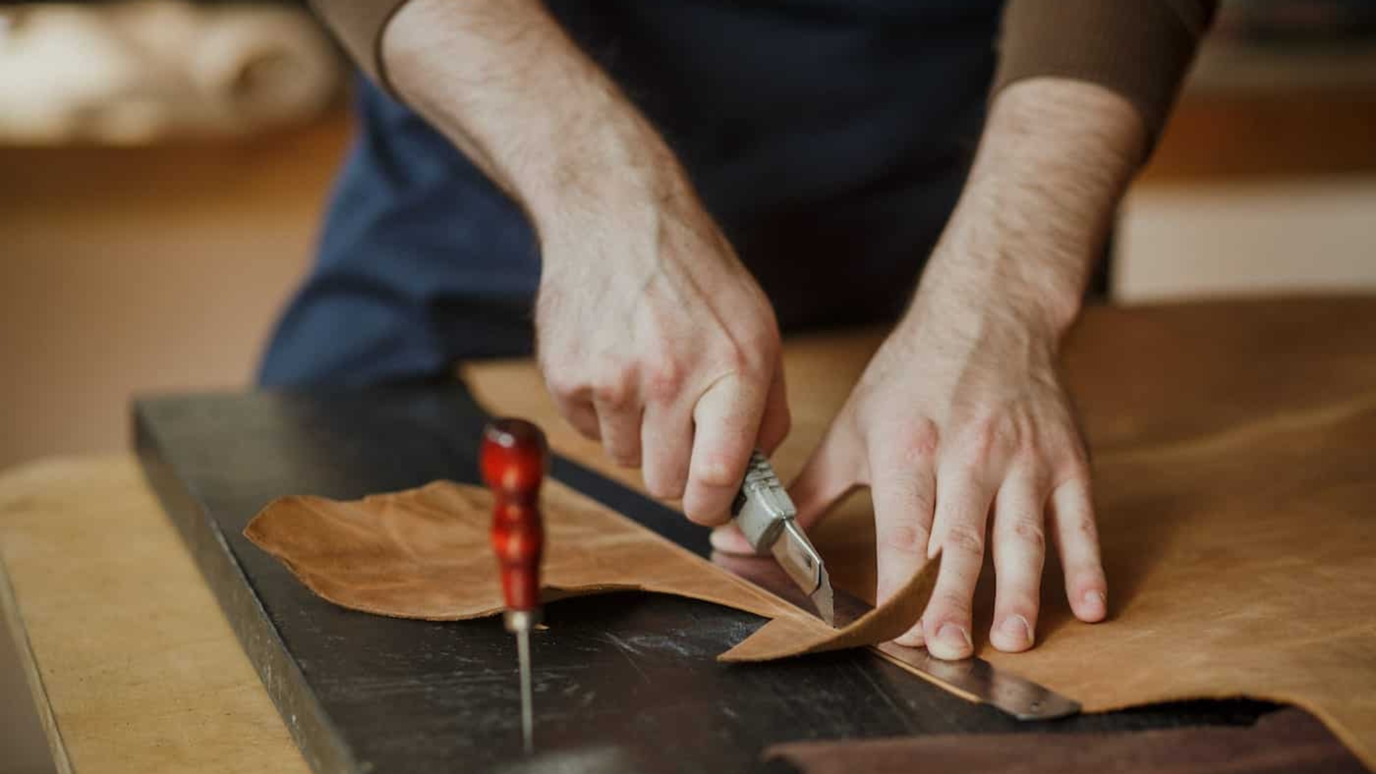 Nahaufnahme. Polstermeister arbeiten mit dem Leder.